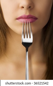 Close Up Of Woman Mouth With Pink Lipstick Keeping A Fork Near The Lips