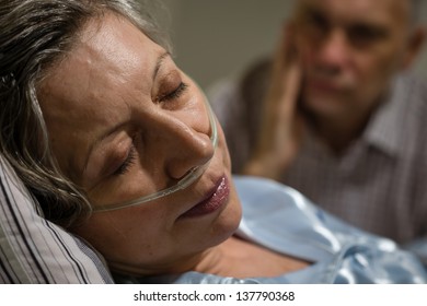 Close Up Of Woman With Nasal Cannula And Worried Husband