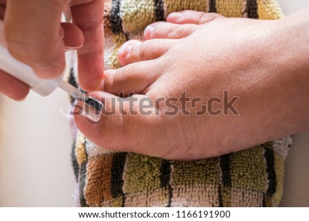 Close Up of a woman painting her toenails