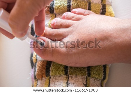 Close Up of a woman painting her toenails