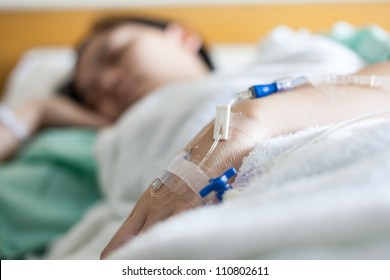 Close Up Of A Woman Patient In Hospital With Saline Intravenous (iv)