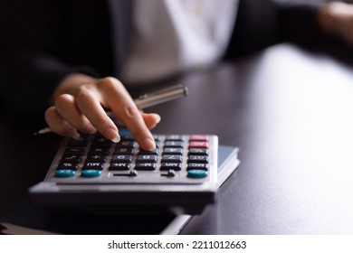 Close Up Of Woman Planning Home Budget And Using Calculator.