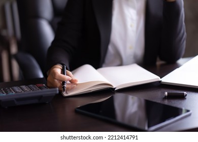 Close Up Of Woman Planning Home Budget And Using Calculator.