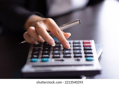 Close Up Of Woman Planning Home Budget And Using Calculator.