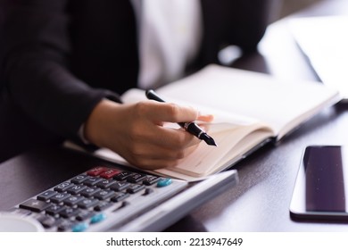 Close Up Of Woman Planning Home Budget And Using Calculator.