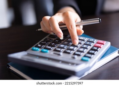 Close Up Of Woman Planning Home Budget And Using Calculator.