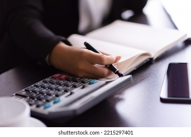 Close Up Of Woman Planning Home Budget And Using Calculator.