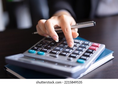 Close Up Of Woman Planning Home Budget And Using Calculator.