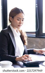 Close Up Of Woman Planning Home Budget And Using Calculator.