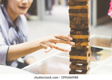 Close Up Woman Playing Jenga Block. For Business Success Concept