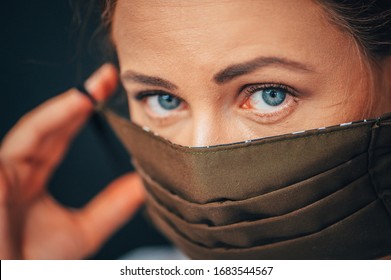 Close up woman portrait, Young woman wearing home made hygienic face medical mask to prevent infection, illness or flu and 2019-nCoV. Black background. Protection against disease, coronavirus. - Powered by Shutterstock