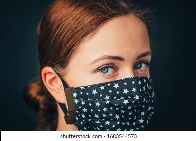 Nahaufnahme Portrait, junge Frau im Haus machte hygienische Gesichtsmaske, um Infektionen, Krankheiten oder Grippe zu verhindern, und 2019-nCoV. Schwarzer Hintergrund. Schutz gegen Krankheiten, Coronavirus.