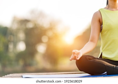 Close Up Woman Practicing Yoga Doing Yoga In Morning Park