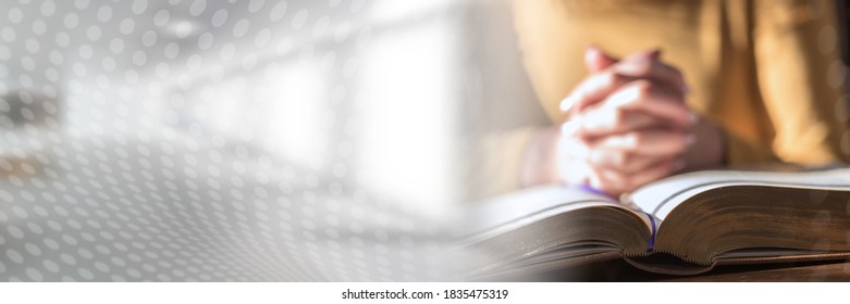 Close Up Of Woman Praying With Her Hands Over The Bible, Hard Light; Panoramic Banner