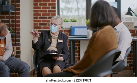 Close Up Of Woman Psychiatrist Talking To People At Aa Group Therapy, Wearing Face Mask. Therapist Giving Advice And Guidance To Patients With Addiction At Rehabilitation Meeting.
