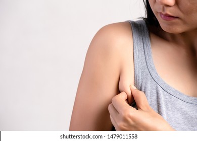 Close Up Woman Pulling Her Skin Underarm. Problem Armpit Fat Skin Concept.