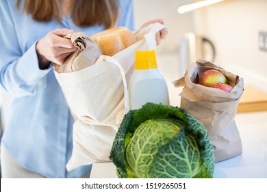 Close Up Of Woman Returning Home From Shopping Trip Unpacking Groceries In Plastic Free Packaging