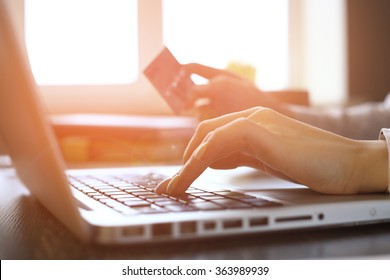 Close Up Of woman Shopping Online Using Laptop With Credit Card