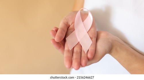 Close up of woman showing pink ribbon symbolizing breast cancer. - Shutterstock ID 2156246627