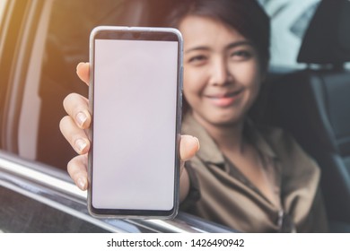 Close Up Woman Showing Smart Phone In The Car.