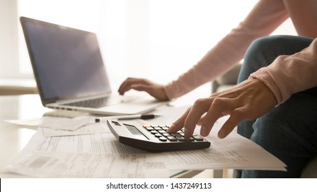 Close Up Of Woman Sit At Home Using Laptop And Calculator Analyze Charges Calculate Monthly Home Expenses, Focused Female Accounting Consider Or Plan Family Budget, Check Utility Bills In Living Room