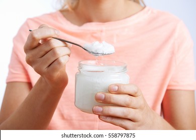 Close Up Of Woman With Spoonful Of Coconut Oil - Shutterstock ID 558797875