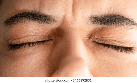 Close up of woman squinting eyes closed - Powered by Shutterstock