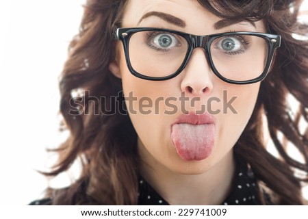 Close up woman sticking her tongue out, isolated on white. Funny girl