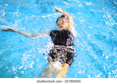 Close up of a woman swimming the backstroke - Powered by Shutterstock