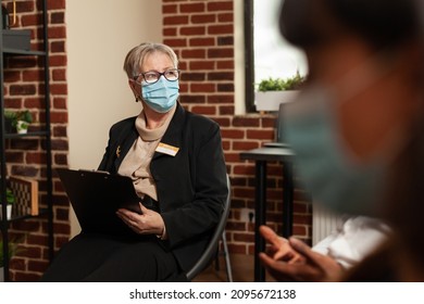 Close Up Of Woman Therapist Listening To People With Addiction At Aa Meeting. Psychotherapist Giving Counseling And Guidance To Patients At Group Therapy Session, Wearing Face Mask.