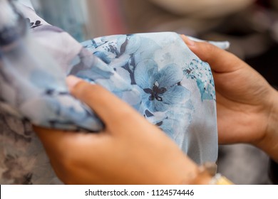 close up of woman touching clothes