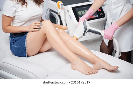Close up woman undergoing laser hair removal at beautician. Salon care with modern diode laser for perfect smooth skin.
