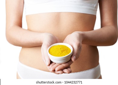 Close Up Of Woman In Underwear Holding Dish Of Tumeric