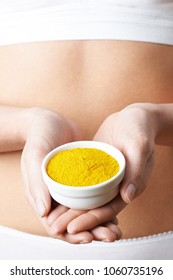 Close Up Of Woman In Underwear Holding Dish Of Tumeric