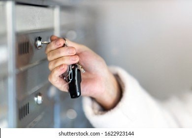 Close Up Of A Woman Unlocking Apartment Mailbox