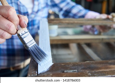 Close Up Of  Woman Upcycling Furniture In Workshop At Home Painting Cabinet                                         - Shutterstock ID 1418786003