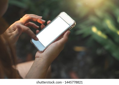 close up woman use hands typing mobile phones and touch screen working search with app devices vintage style in park with sunrise and blur nature background.