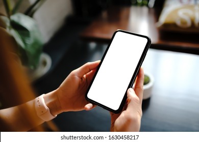Close up of woman using cell phone,sending massages on the coffee shop.having sunbath.Phone with black screen,texting,video calls, - Shutterstock ID 1630458217