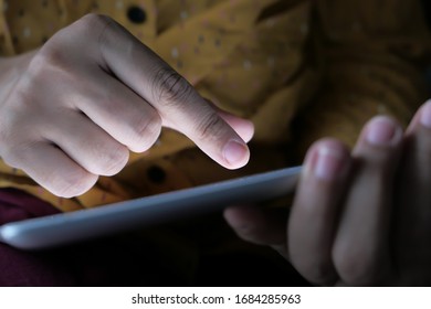 Close up woman using digital tablet indoor.