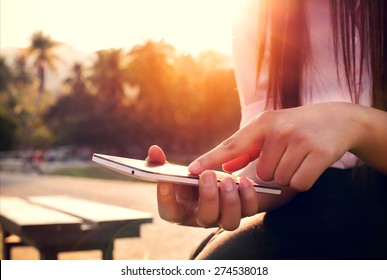 Close Up Of A Woman Using Mobile Smart Phone In Sunset With Outdoor, Nature Background. (vintage Color Tone)