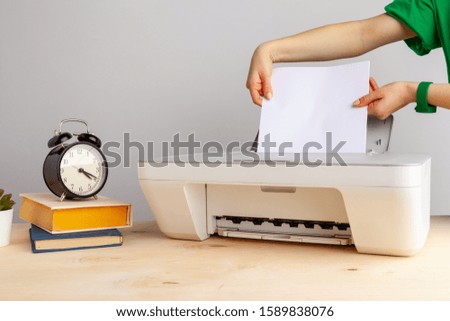 Close up of woman using a printer machine
