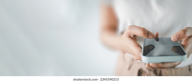 Close up of woman using smartphone over white background with copyspace for put text,icon,logo concept for banner,wallpaper,background idea. - Shutterstock ID 2345590215