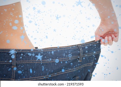 Close Up Of A Woman Waist In A Too Big Pants Against Snow Falling