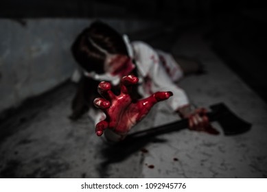 Close up woman wear white shirt with blood,She has axe in hand,Horror movie concept,Thailand people