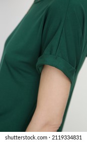 Close Up Of Woman Wearing Green Rolled Up Sleeve T-shirt