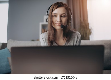 Close Up Of Woman Wearing Headset While Working On Laptop