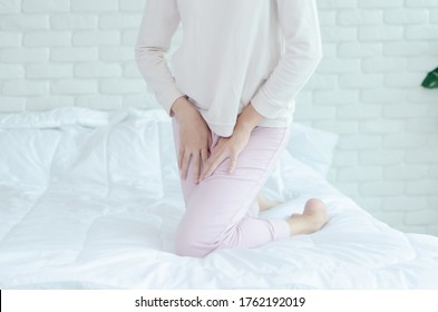 Close Up Woman Wearing Pink Pants The Itching On Vaginal. The Woman's Hand Placed Between Her Legs. She Has Itching At The Vaginal.