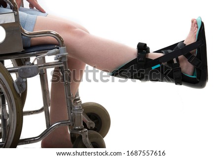 Close up of woman in wheelchair and foot orthosis,night orthosis