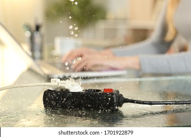Close up of woman working at danger of electrocution for water leaks falling on a socket bank over a desk at home
