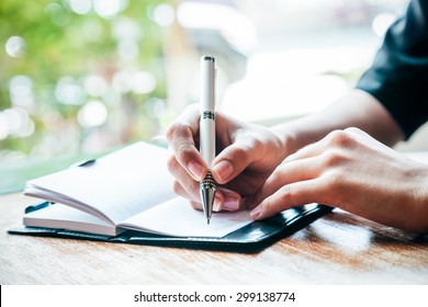 Close Up Of Woman Writing Her Journal 